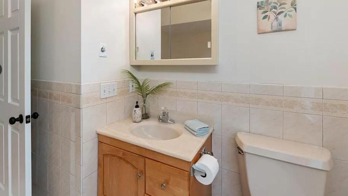 Compact Bathroom with Practical Wood Vanity and Neutral Tiles