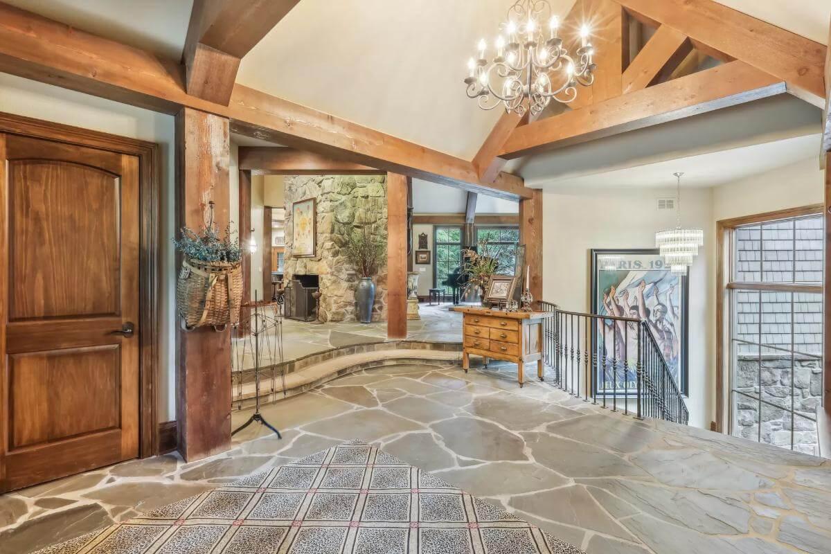 Grand Entrance with Timber Beams and Stone Flooring
