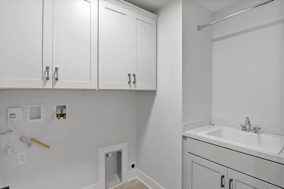 Efficient Laundry Hub with Crisp White Cabinetry