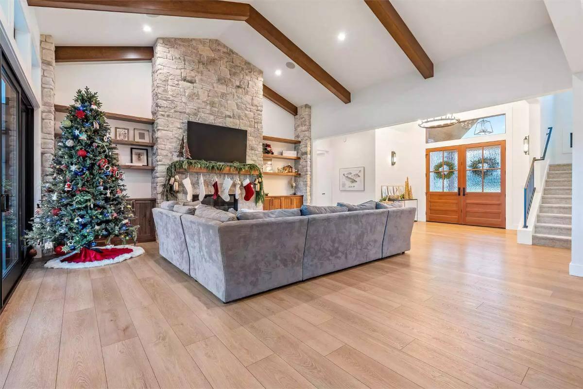 Living Room with a Stone Fireplace and Inviting Beamed Ceiling