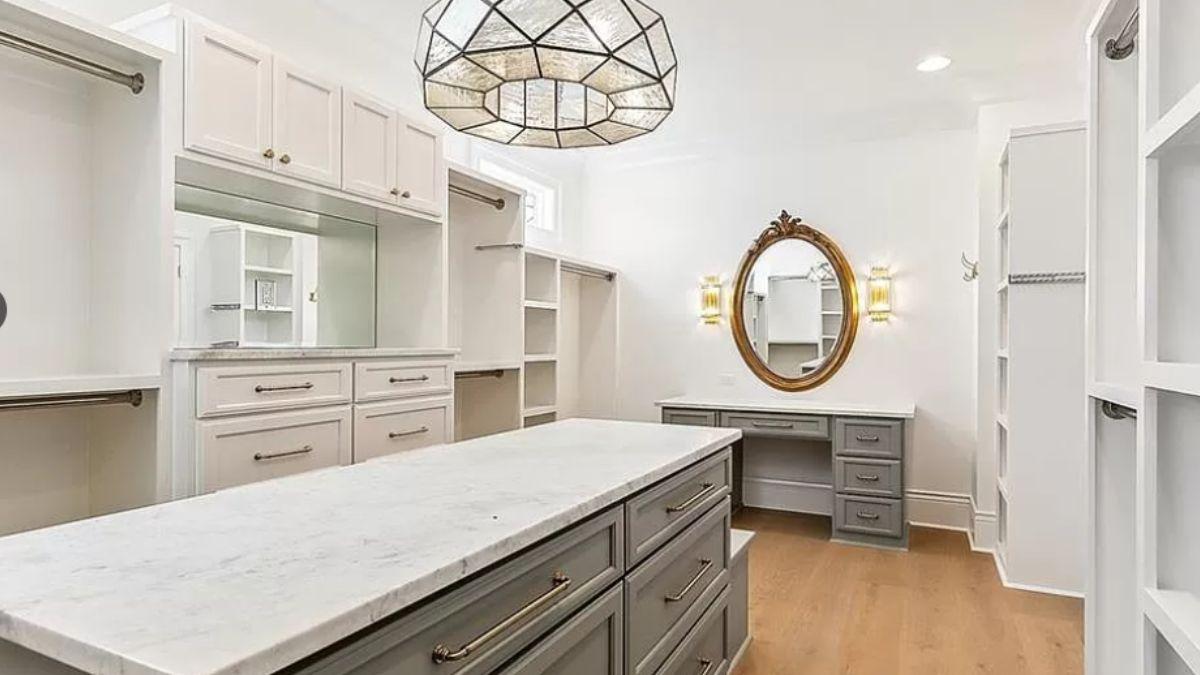 Explore the Spaciousness of This Closet with an Elegant Light Fixture