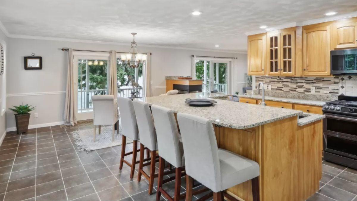 Gather Around the Granite Island in This Spacious Craftsman Kitchen