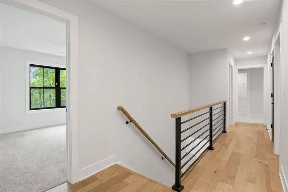 Simple Hallway with Modern Black Railings and Natural Light