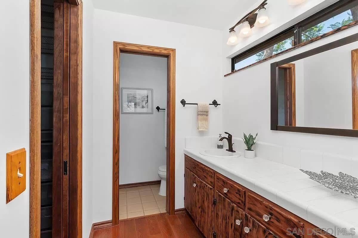 Notice the Rustic Wood Accents in This Functional Bathroom Layout