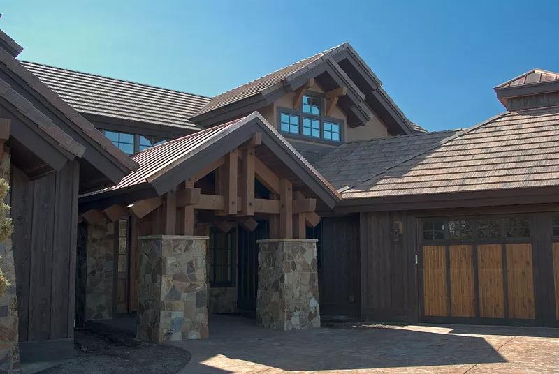Notice How the Timber Framing Complements the Stone Pillars in This Craftsman Entrance