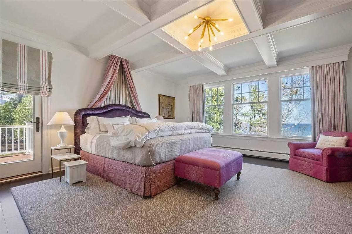 Bright and Inviting Bedroom with a Canopy Bed and Scenic Views