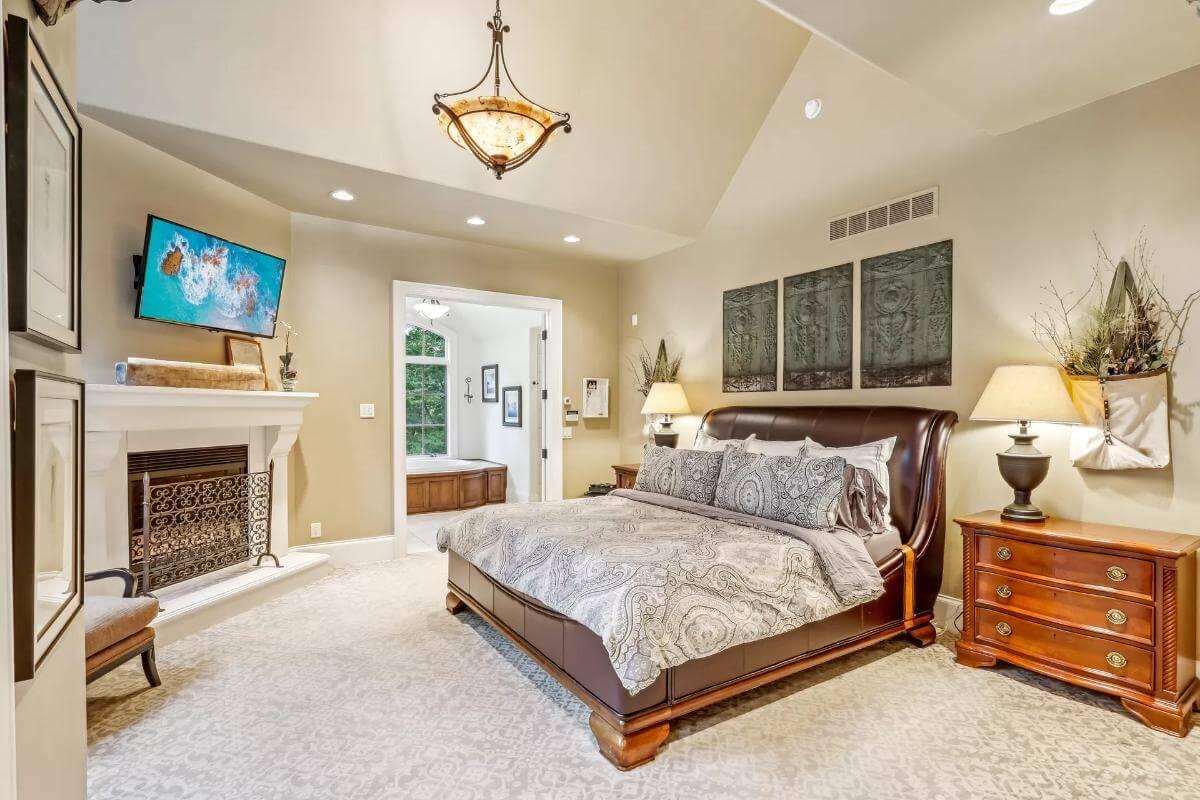 Vaulted Ceilings and Fireplace Bring Warmth to This Serene Bedroom