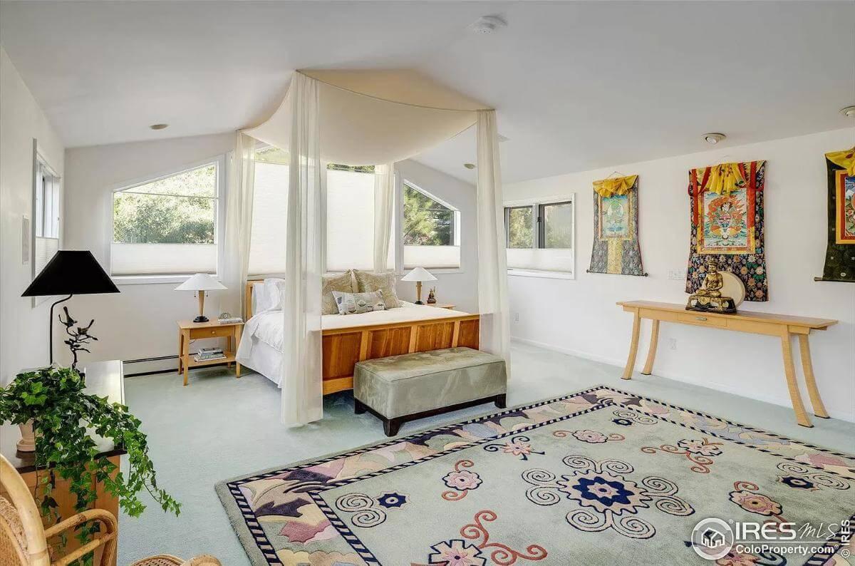 Elegant Bedroom with Draped Canopy Bed and Cultural Decor