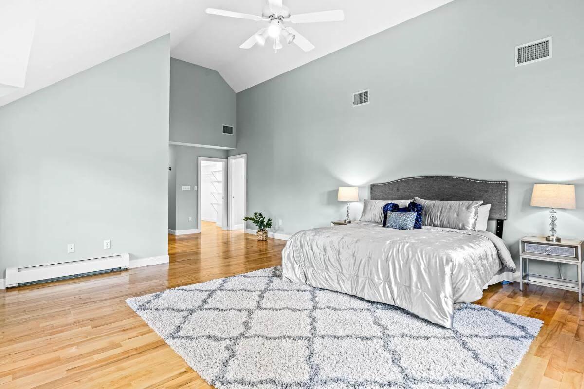 Unwind in This Spacious Primary Bedroom with Vaulted Ceilings