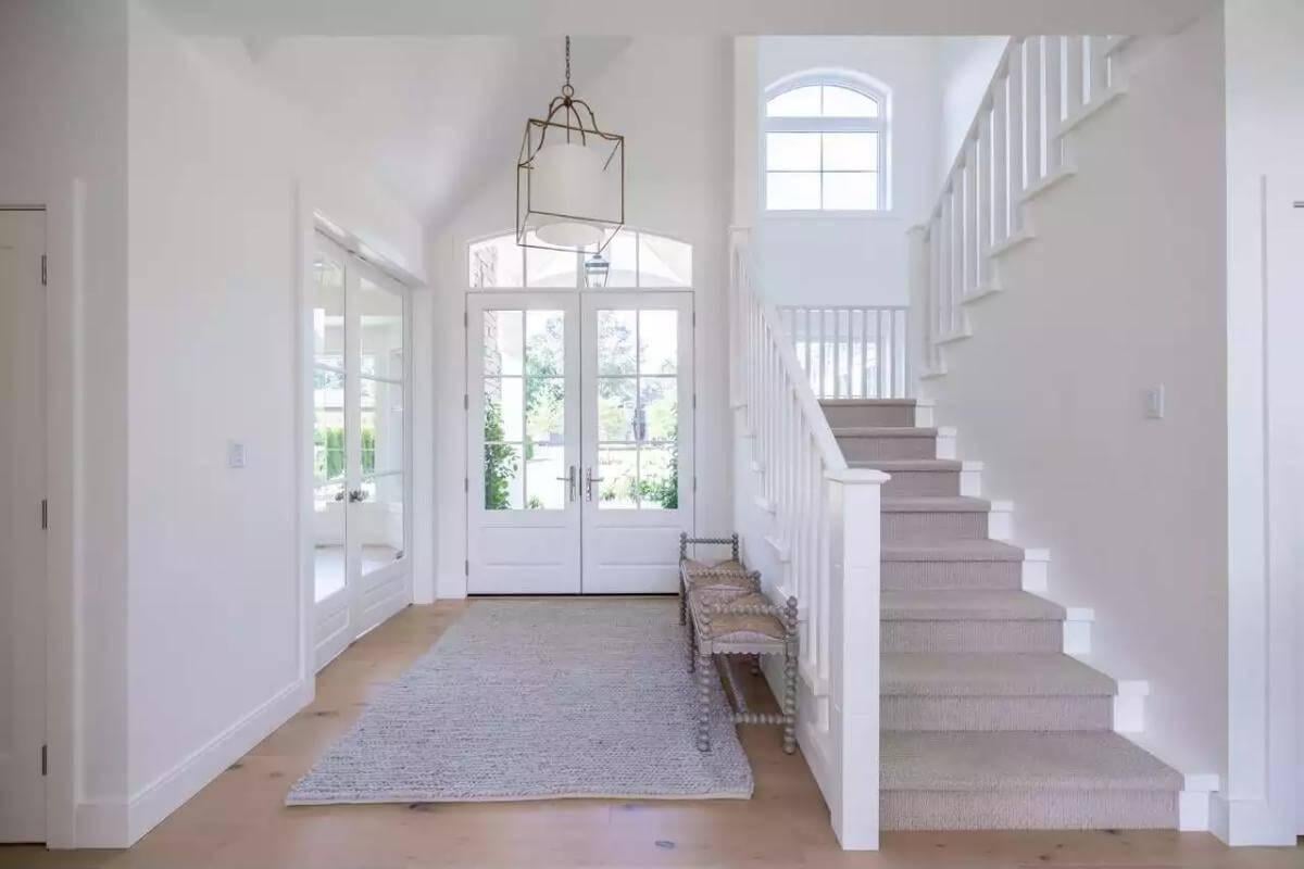 Step Into This Light-Filled Entryway with Elegant Staircase