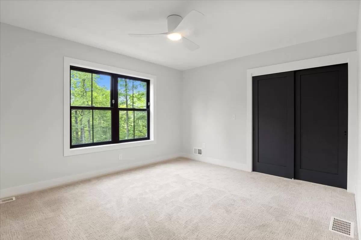 Uncluttered Bedroom with Forest Views and Modern Finishes