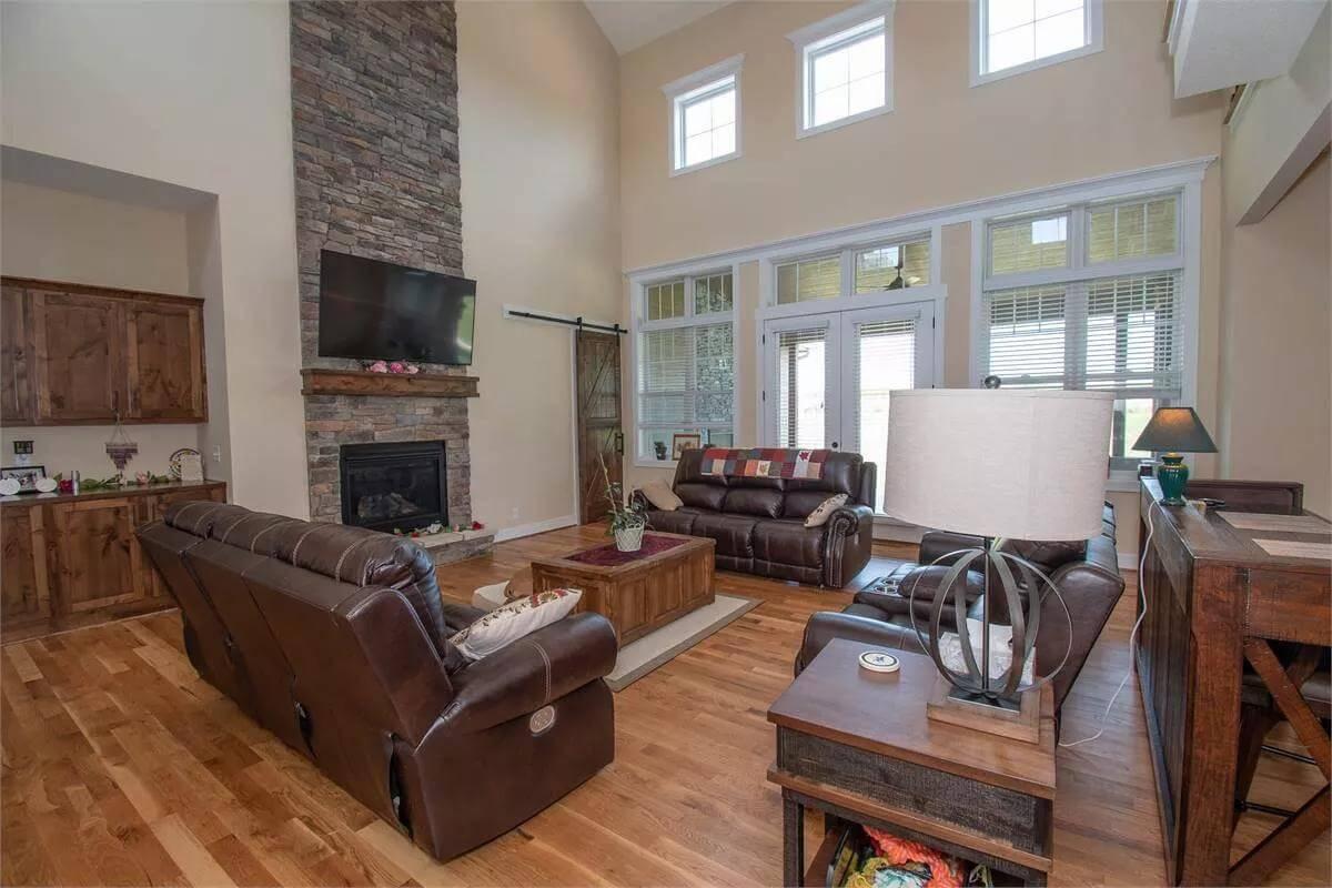 Check Out the Soaring Stone Fireplace in This High-Ceiling Living Room