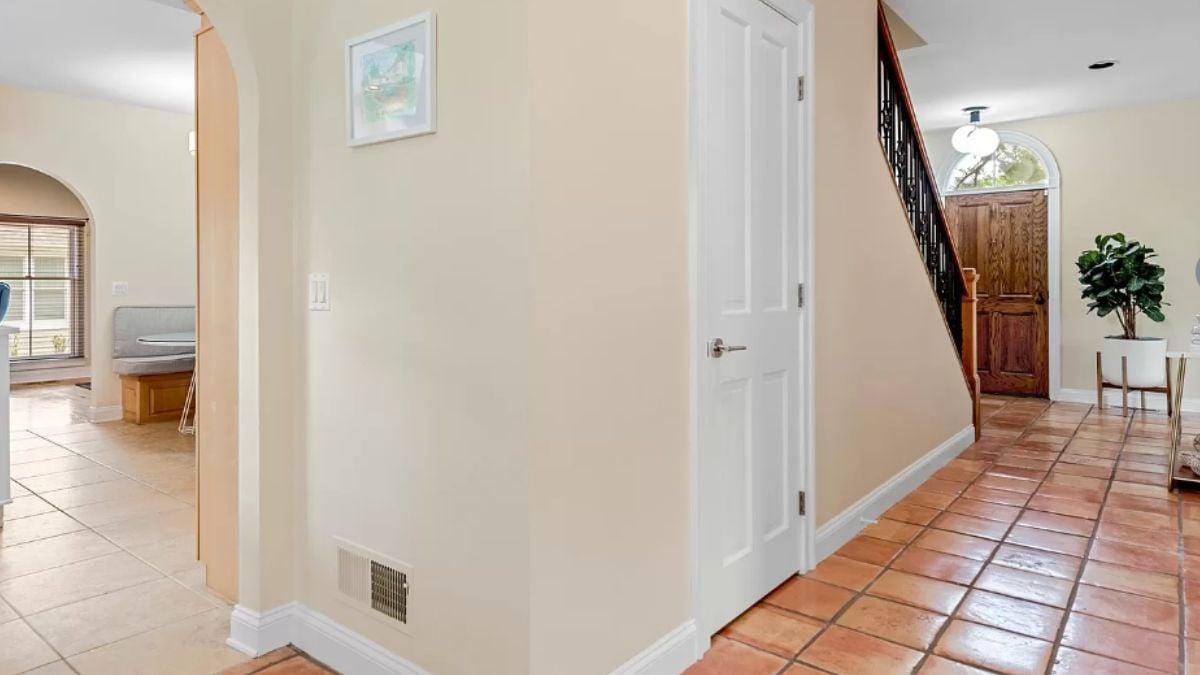 Welcoming Entryway with Terracotta Tiles and Iron Railing
