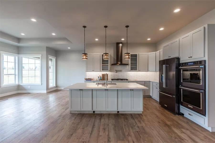 Notice the Striking Pendant Lights in This Spacious Open-Concept Kitchen