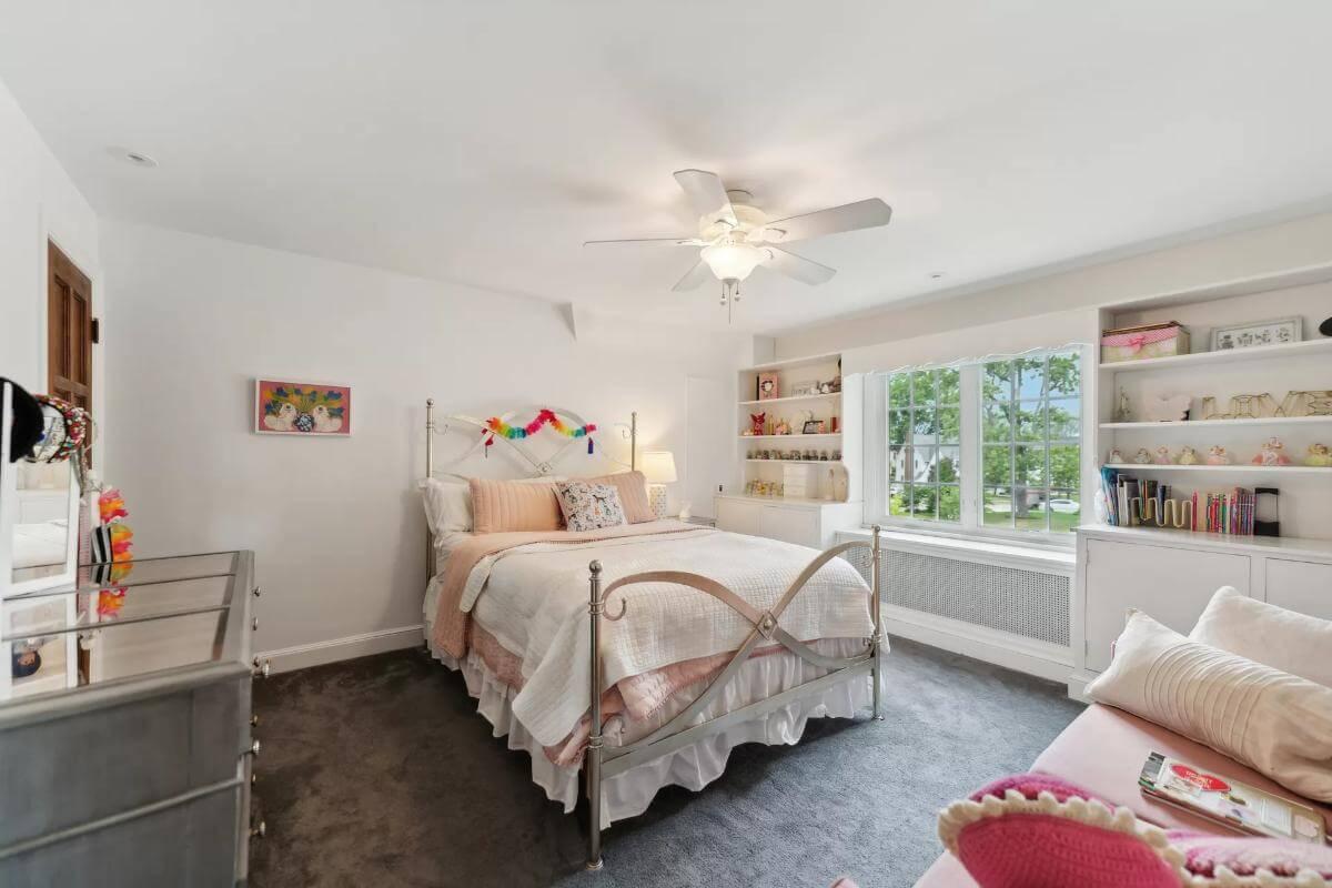 Charming Bedroom with Built-In Shelves and a Cozy Nook