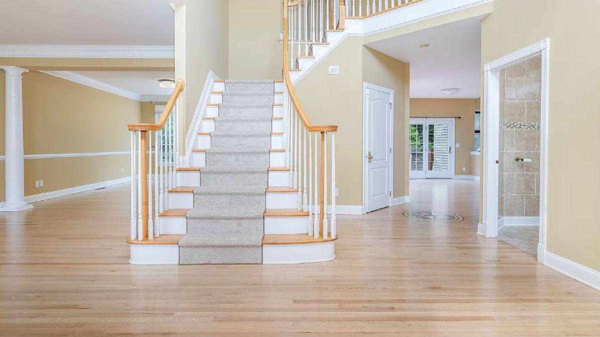 Grand Foyer with Sweeping Staircase and Elegant Woodwork