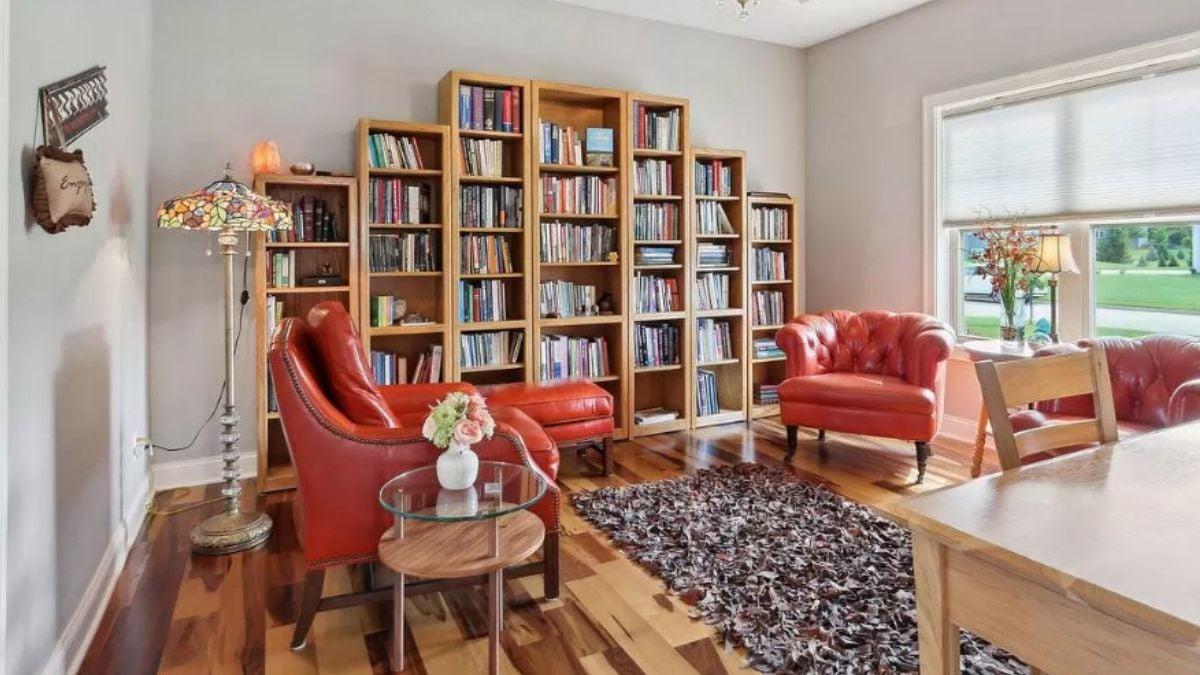 Spot the Vibrant Red Seating in This Charming Library Nook