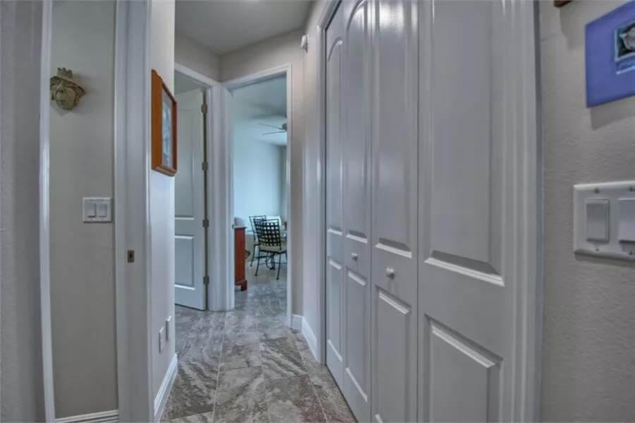 Exploring the Hallway with Sleek Tile Flooring and Ample Storage