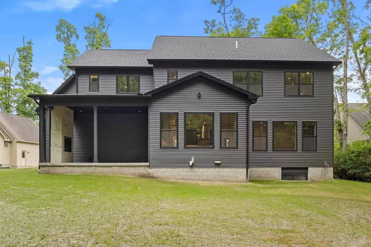 Dark Siding and Simple Lines Stand Out Against the Natural Backdrop