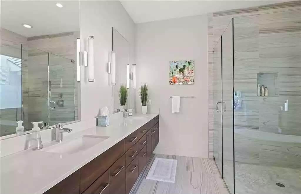 Sleek Bathroom Design with Dual Vanities and Glass Shower