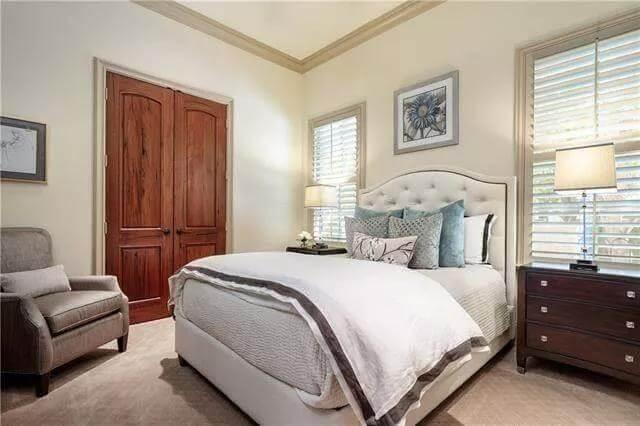 Tranquil Bedroom with a Upholstered Headboard and Plantation Shutters