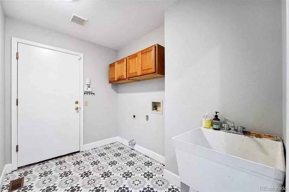 Functional Laundry Room with Geometric Tile Flooring