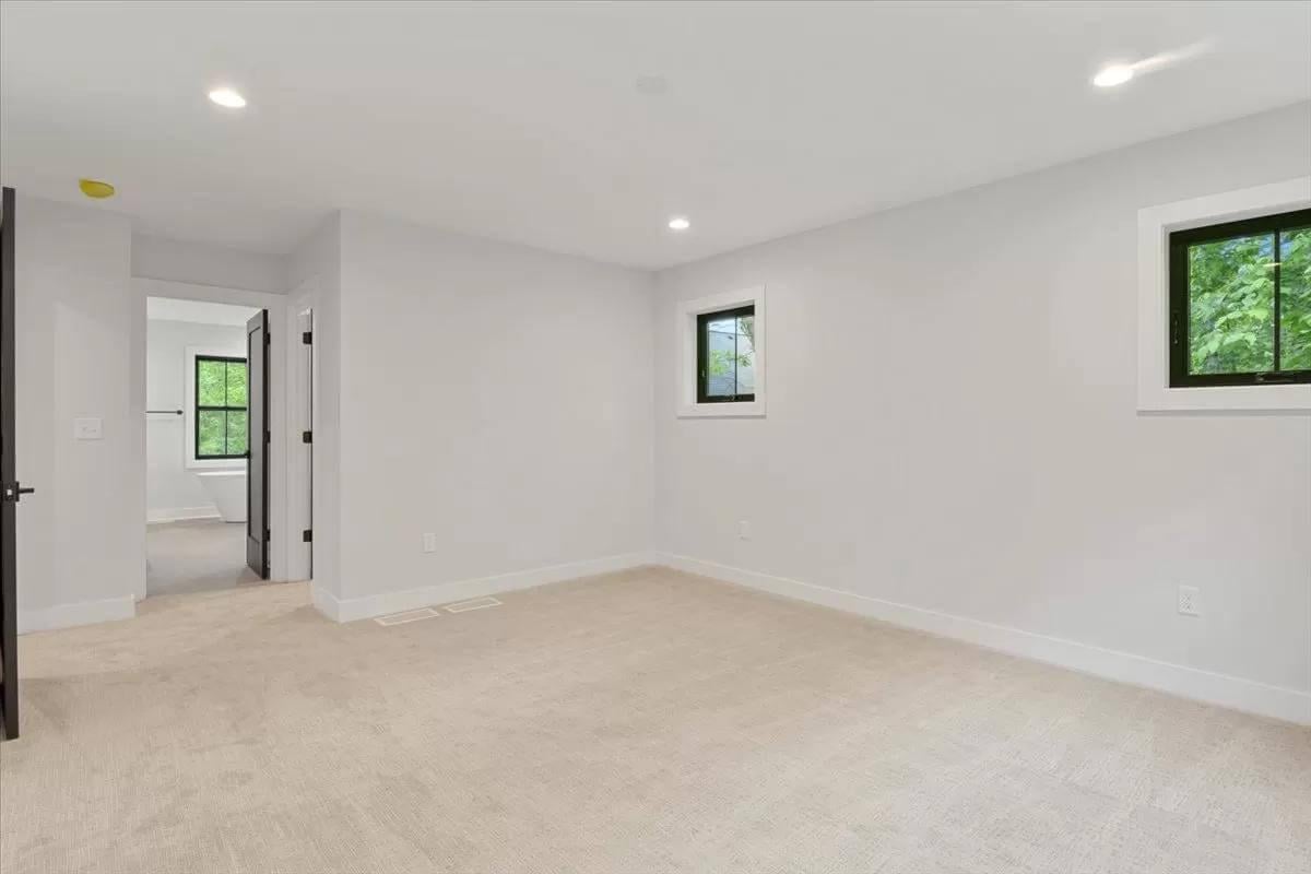 Blank Canvas Room with Dual Windows Capturing Nature