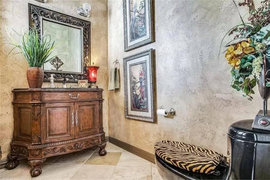 Eclectic Half-Bathroom with Ornate Vanity and Zebra Accents