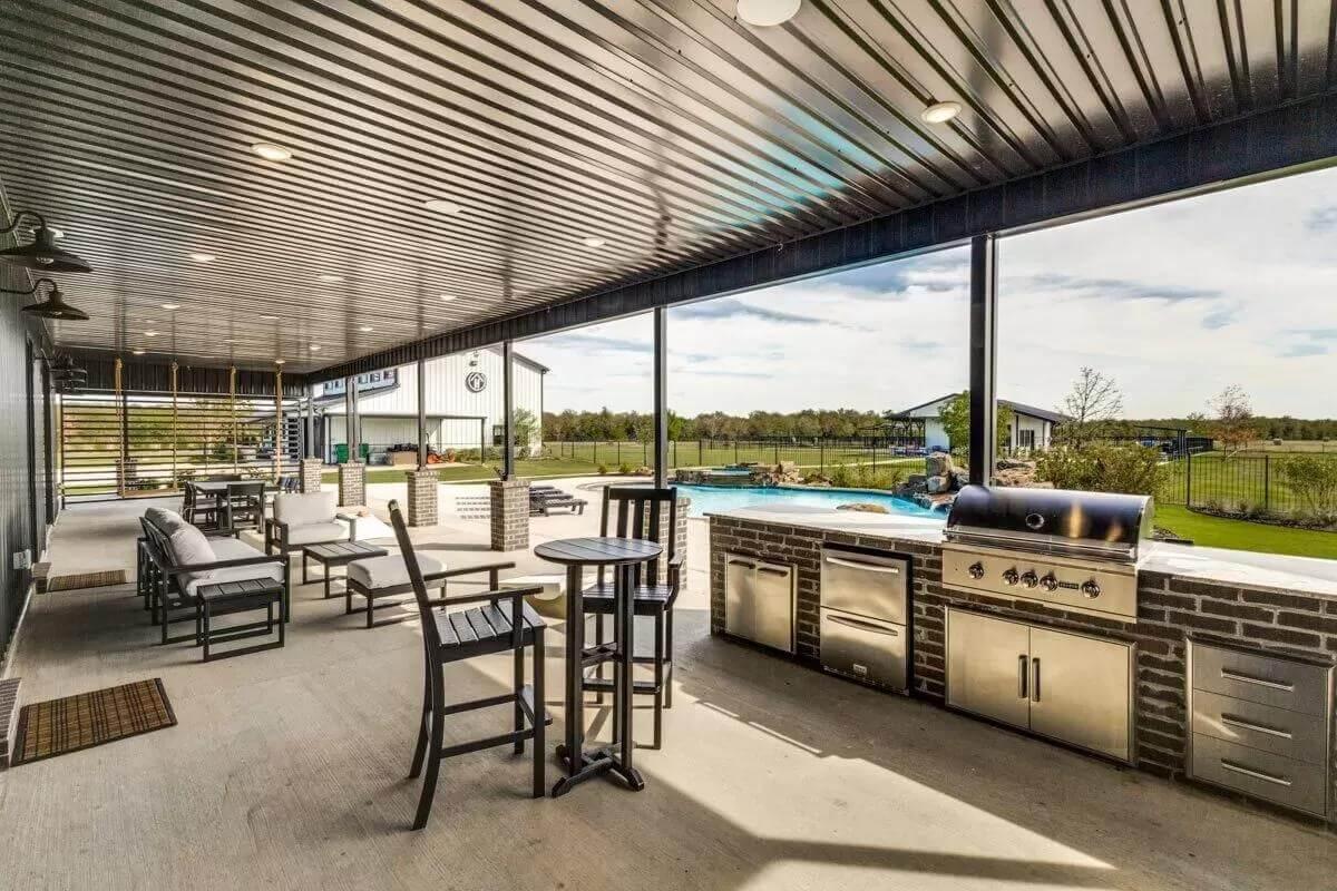 Patio Paradise with Sleek Metal Ceiling and Outdoor Kitchen