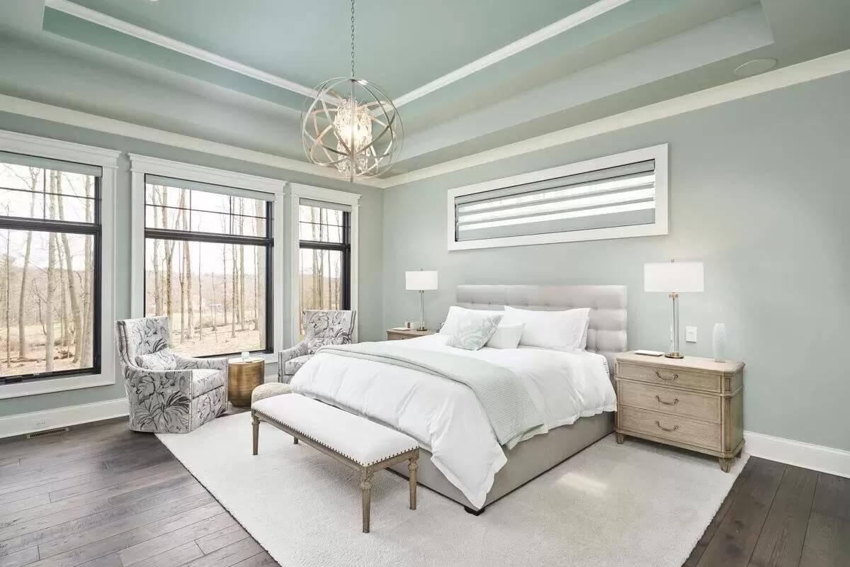 Serene Bedroom with Elegant Tray Ceiling and Woodland Views