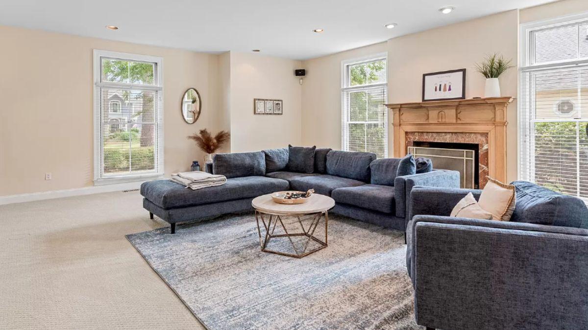 Relax in This Spacious Living Room with a Classic Wooden Mantel