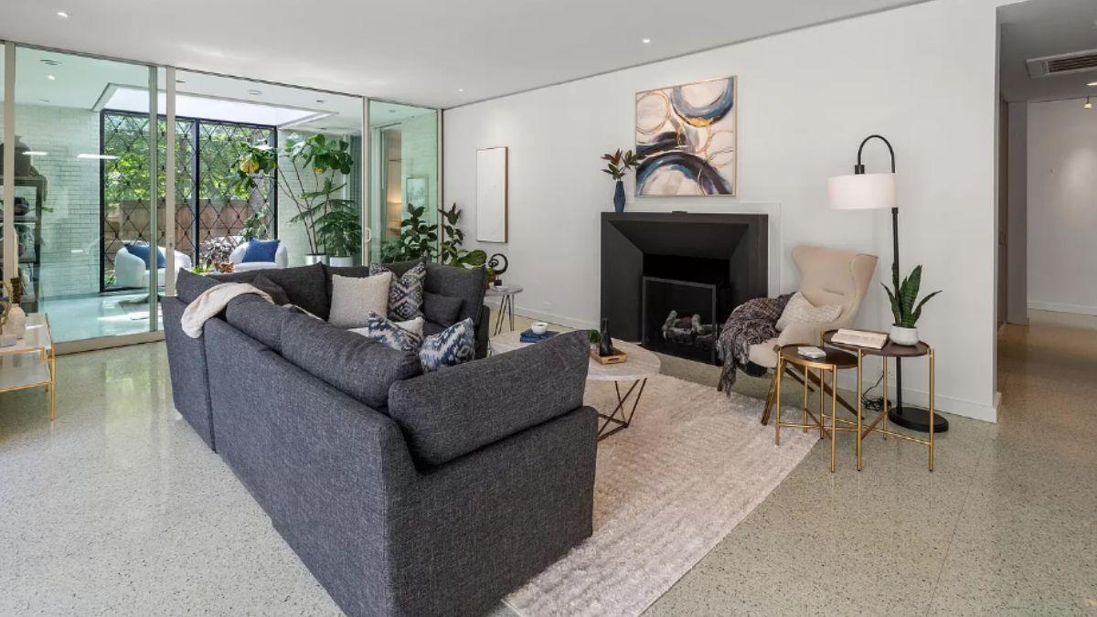 Curl Up by the Modern Fireplace in This Inviting Living Room