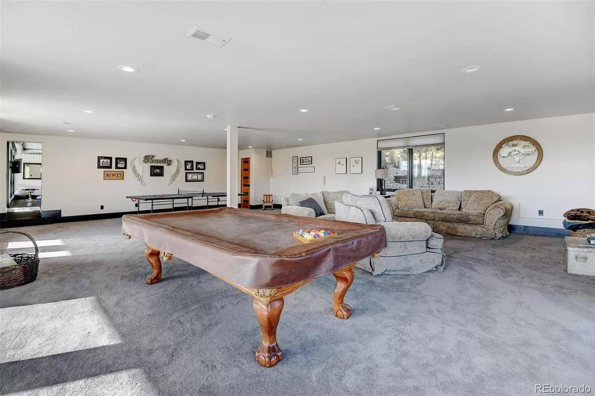 Expansive Game Room with Vintage Pool Table and Cozy Seating