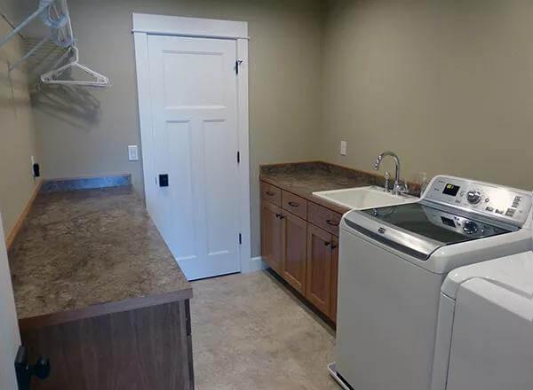 Efficient Laundry Room with Utility Sink and Ample Counter Space
