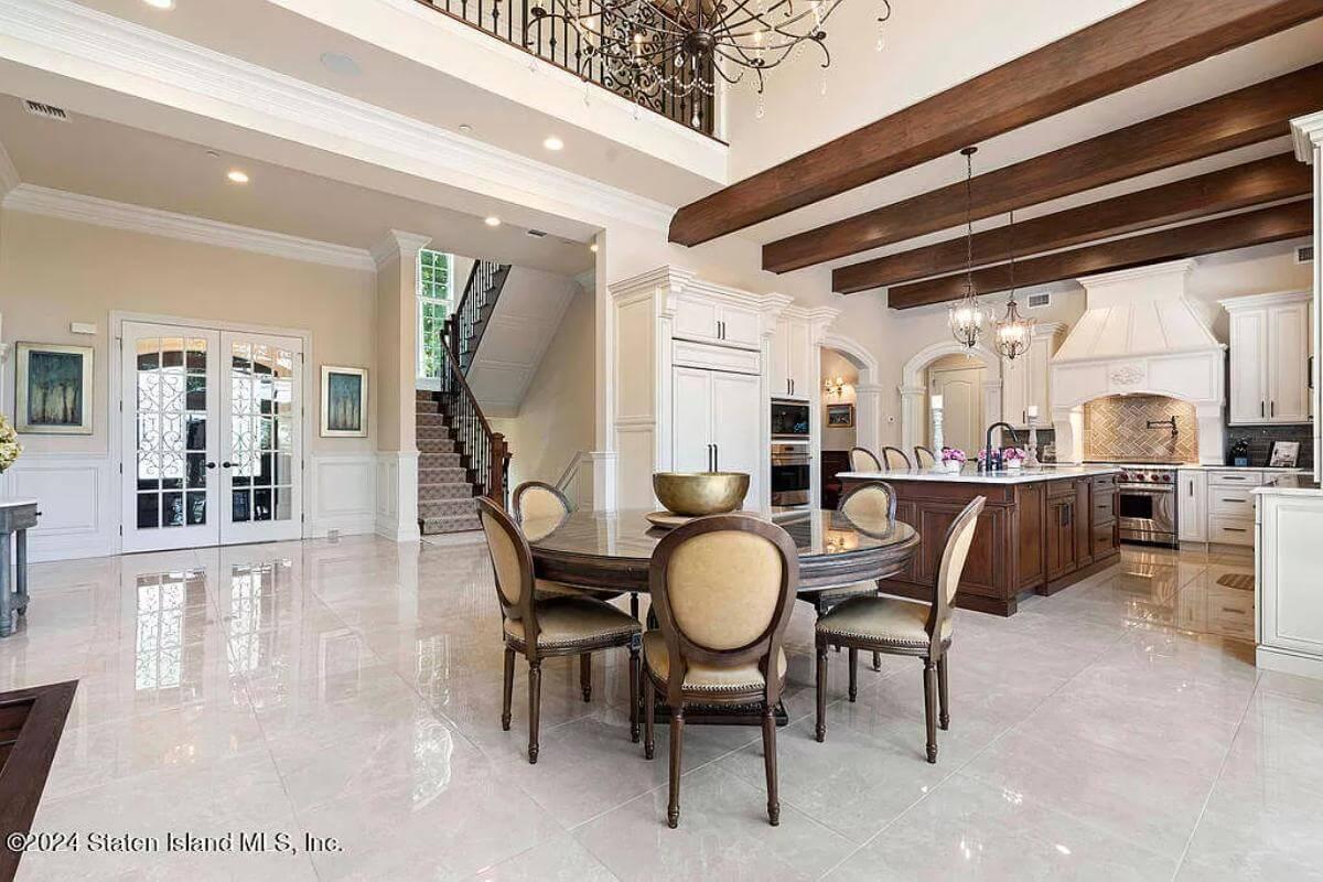 Admire the Exposed Beams and Grand Chandelier in This Open Kitchen