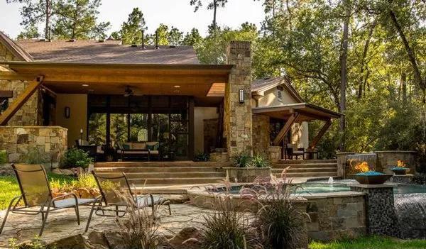 Unwind by the Rustic Stone Fireplace in This Outdoor Haven