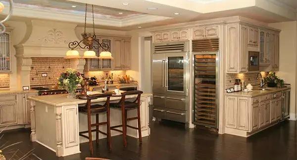 Experience the Charm of Ornate Cabinetry and a Built-In Wine Fridge