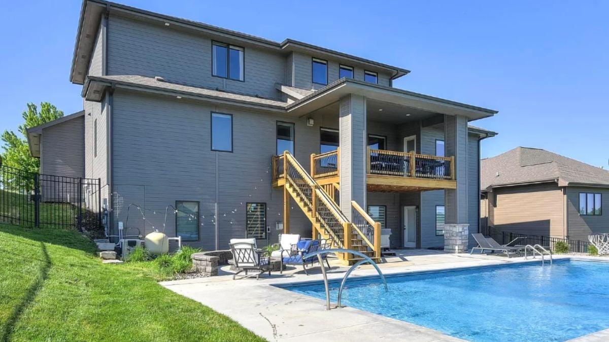 Step into Relaxation with This Backyard Pool and Covered Patio Space