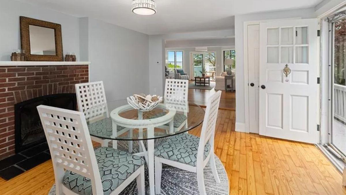 Look at This Cozy Dining Area with Brick Fireplace and Glass Table