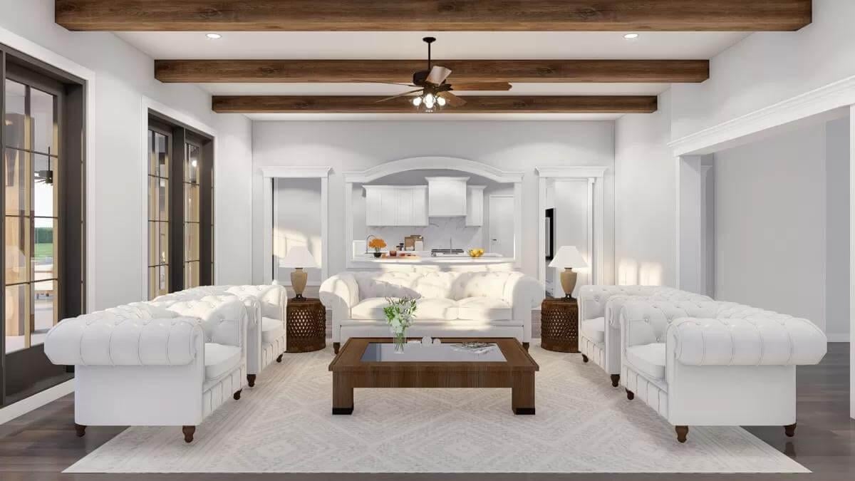 Open-Concept Living Room with White Tufted Sofas and Exposed Beams