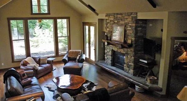 Discover the Heart of the Home: A Great Room with Vaulted Ceilings and Stone Fireplace
