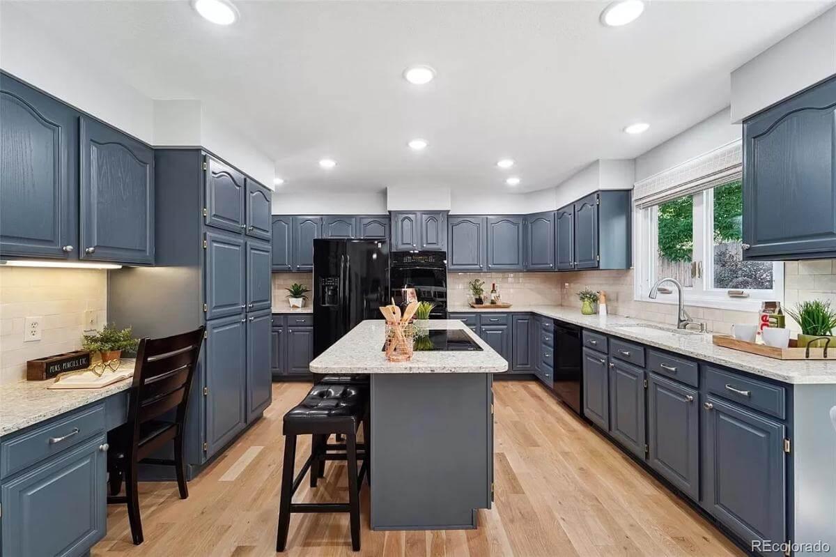 Admire the Extensive Cabinetry and Central Island in This Functional Kitchen