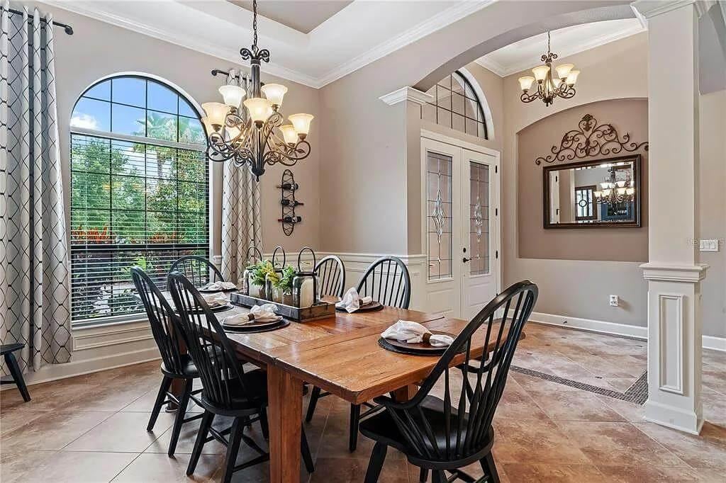 Graceful Dining Room with Arched Features and Chic Chandelier