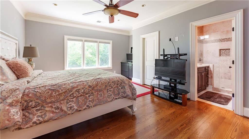 Check Out the Relaxing Bedroom Featuring Warm Wood Floors and Elegant En Suite