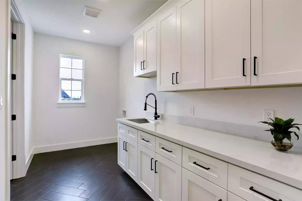 Notice the Sleek Sink Design in This Functional Laundry Room