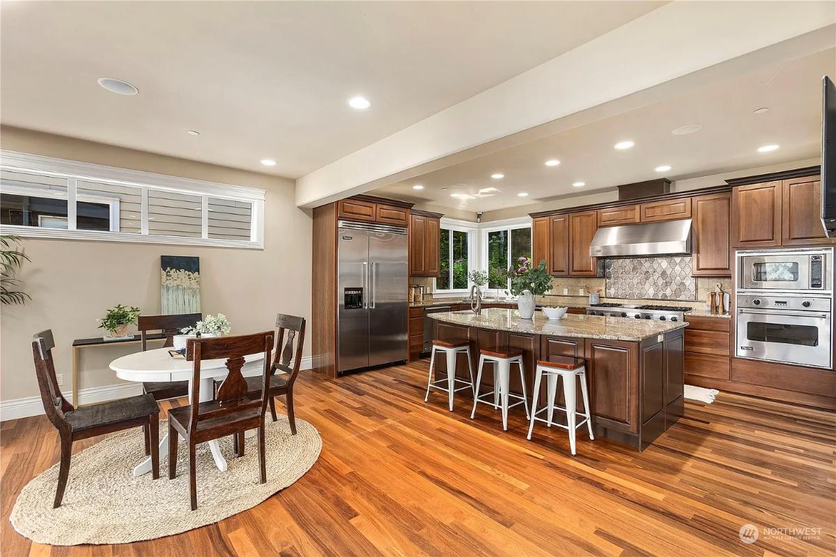 Warm Wood Kitchen with Granite Island and Breakfast Nook
