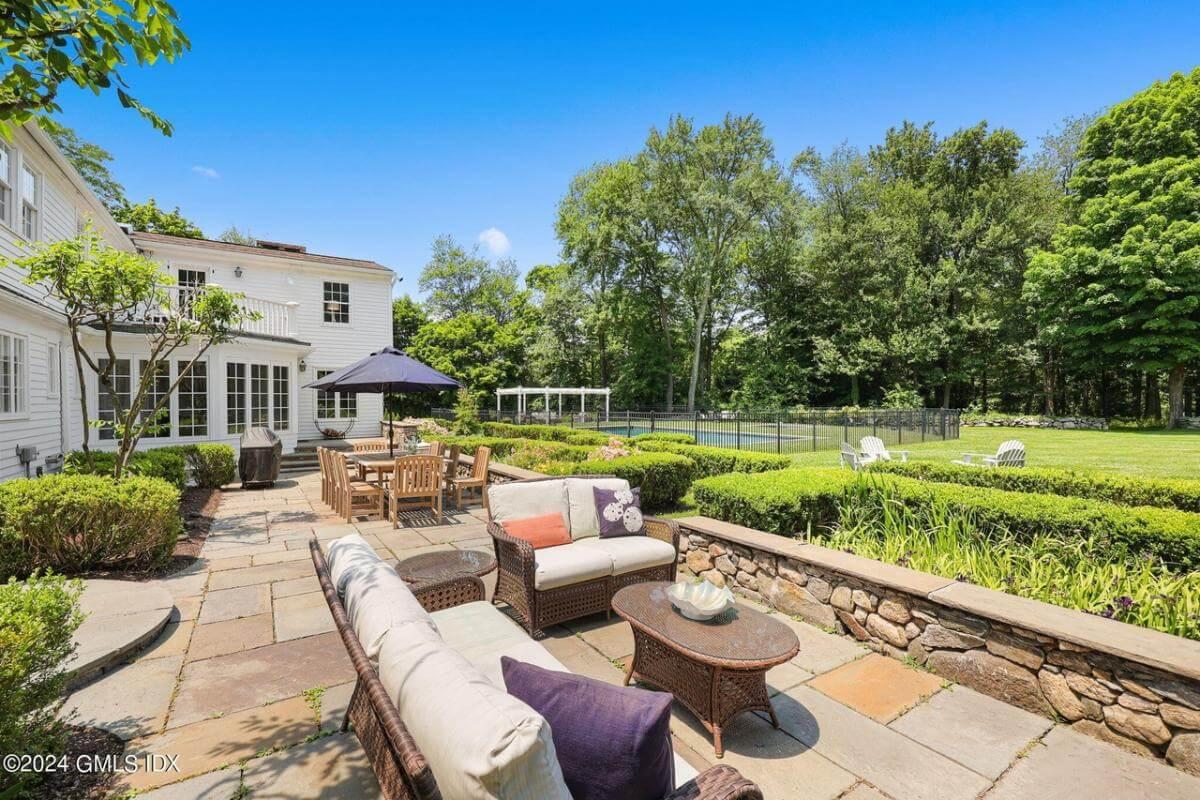 Check Out This Classic Patio with Wicker Seating and Stone Details
