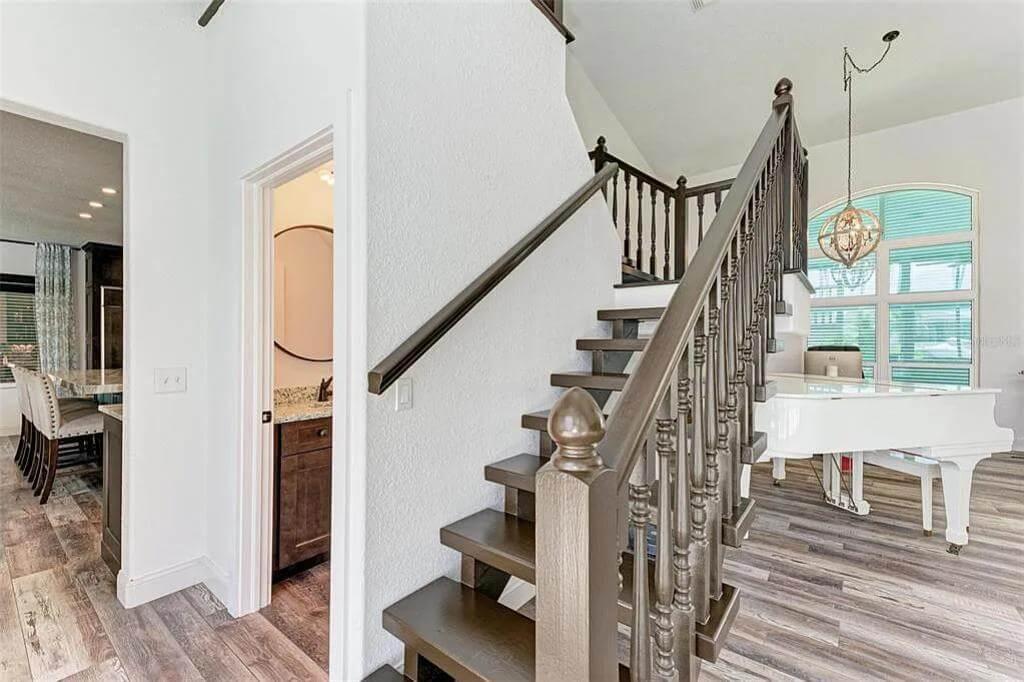 Notice the Elegant Spiral Staircase and Chic White Piano in This Light-Filled Space