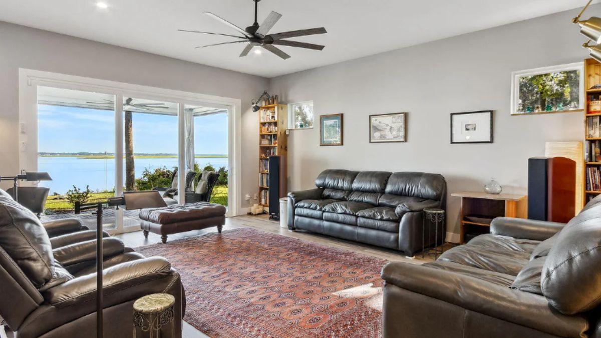 Relax in This Living Room with Expansive Water Views and Leather Seating