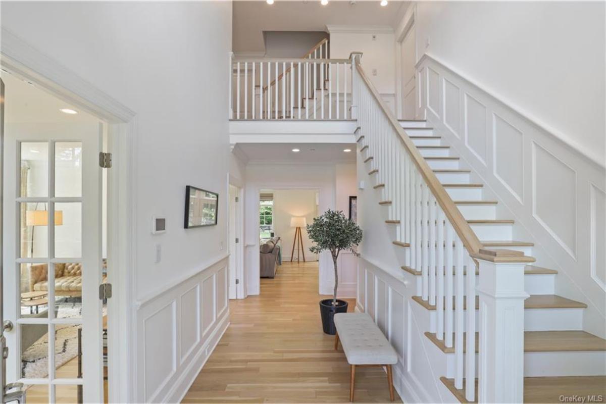Step into This Light-Filled Foyer with Timeless Wainscoting